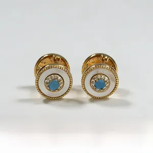 Detailed close-up of retro turquoise and mother of pearl round stud earrings