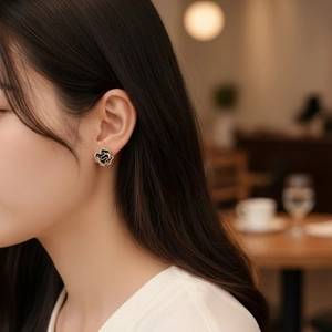Elegant black enamel camellia earrings with sparkling crystals for a vintage look