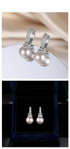 Detailed view of baroque pearl earrings with zircon-inlaid silver clasp on silk