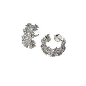 Elegant silver C-shaped stud earrings featuring pave-set crystals and organic textures