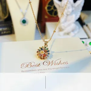 Close-up of golden daisy necklace featuring vibrant multicolored crystal petals and a beaded chain