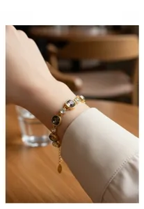 Detail of colorful geometric crystal bracelet in gold plating on a woman's wrist