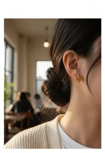 Detailed view of maple leaf stud earrings with amber crystals in vintage gold setting