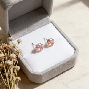 Pink hexagonal cut crystal stud earrings presented in a luxury velvet jewelry box