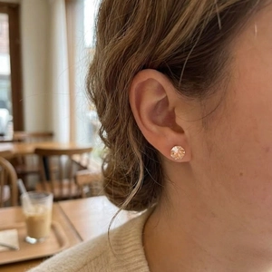 Elegant champagne crystal stud earrings in a classic four-prong setting on rose gold base