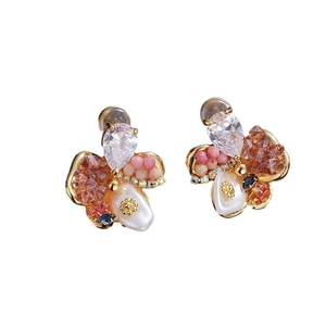 Detailed macro shot of vintage floral stud earrings with pearls and crystal inlay