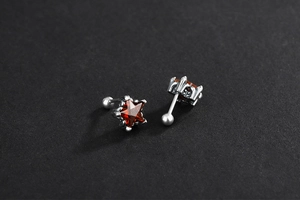 Vue macro de boucles d'oreilles étoile en argent 925 avec pierres rouges et fermoir vissé