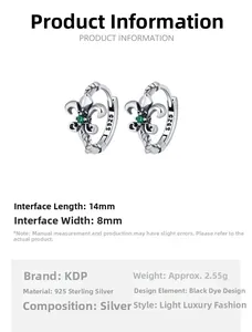 Detailed macro view of retro 925 silver iris hoop earrings with green zircon emerald