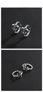 Detail of vintage 925 silver iris earrings with emerald zircon and s925 hallmark