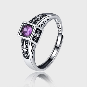 Macro detail of 925 sterling silver ring featuring purple zircon and vintage cross engraving