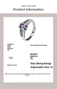 Macro detail of vintage 925 silver cross ring with purple zircon and engraved textures