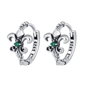 Macro view of S925 sterling silver hoop earrings with emerald zircon fleur-de-lis