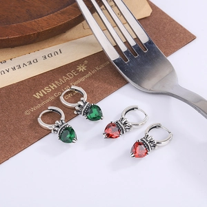 Detailed view of vintage S925 silver crown heart earrings with red and green gemstones