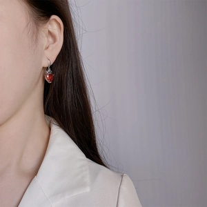 925 silver vintage heart shaped ruby earrings with crown detail worn by a model