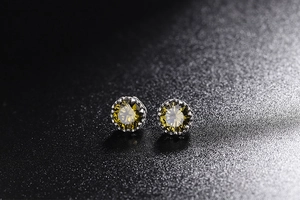 Dettaglio macro di orecchini con pietre rotonde verde oliva e montatura in argento