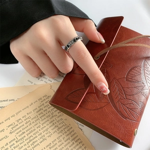 Vintage S925 silver open ring with black zircon cross relief pattern on retro background