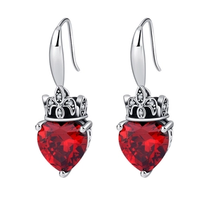 Detail of red heart-shaped gemstone earrings with silver crown setting and tiny zircons