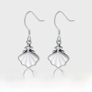 Detail of S925 silver hook earrings featuring white shell pendant and zircon inlay