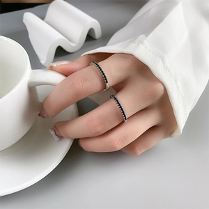 Elegant 925 sterling silver rainbow rings with blue and green crystals on hand