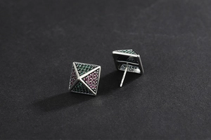 Detail of 925 silver pyramid stud earrings with green and pink micro-pave zircons