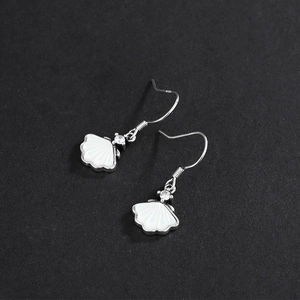 Elegant 925 sterling silver shell earrings with clear cubic zirconia on dark surface