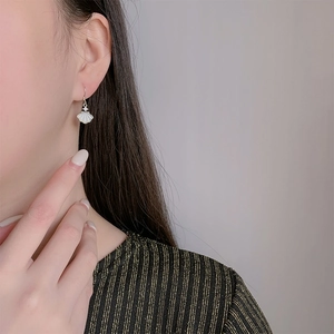 Elegant 925 sterling silver shell earrings for women worn by a model for a graceful look