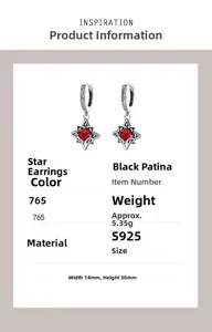 Macro shot of 925 sterling silver star earrings with red stone and retro finish