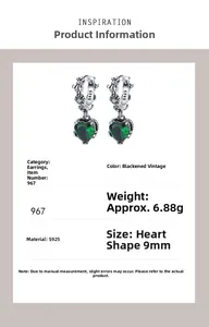 Detail of S925 silver heart earrings with green gemstones and retro carved patterns