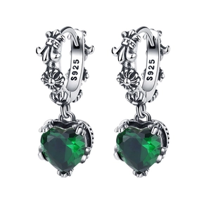 Detail of S925 sterling silver earrings with gothic engraving and green heart stones