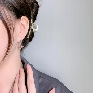 925 silver star earrings with a vibrant red stone pendant shown on a model
