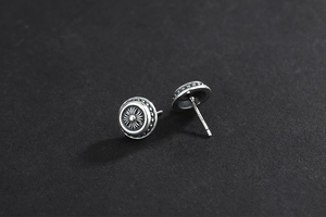 Macro shot of 925 sterling silver retro stud earrings with engraved floral pattern