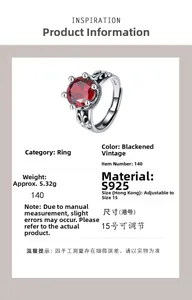 Detailed macro of vintage S925 silver crown ring with red zircon and lily engraving