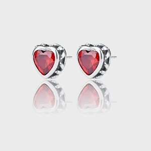 Detail of vintage 925 silver heart stud earrings with red crystal and crown setting