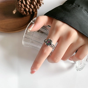 Detailed macro shot of vintage crown ring with rainbow zircon and intricate carvings
