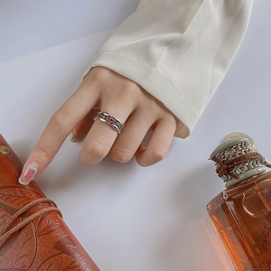 Exquisite silver open ring with red zircons in a multi-layer interlaced hollow design
