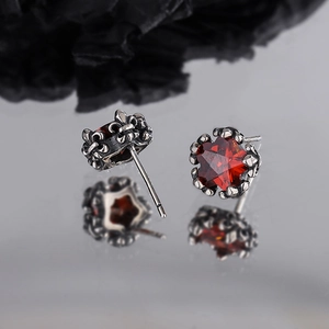 Vintage silver star earrings with red zircon and ornate iris engravings in a retro style