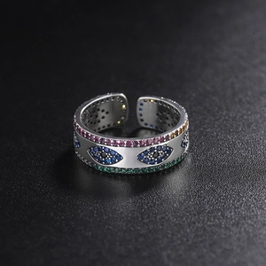 Macro shot of 925 sterling silver ring with multi-color pave diamonds and eye design detail