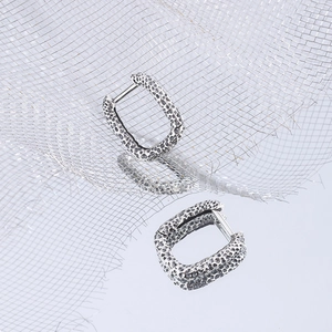 925 silver geometric square hoop earrings with textured hammered finish on a mirror surface