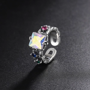 Detailed macro of a vintage 925 silver ring featuring a square iridescent gemstone