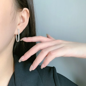 S925 sterling silver geometric U-shaped hoop earrings with sparkling pavé zircons on model