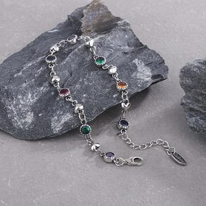 Sterling silver chain bracelet with colorful zircons and solid heart charms on stones