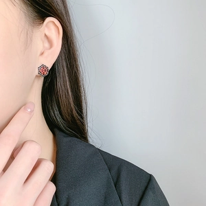 Vintage S925 silver flower stud earring with red garnet zircon on model wearing black suit