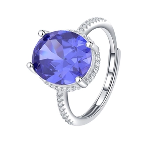 Detailed macro of S925 silver ring with oval blue gemstone and micro-pave diamonds