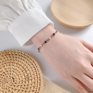 Sterling silver chain bracelet with colorful zircon heart charms on female wrist