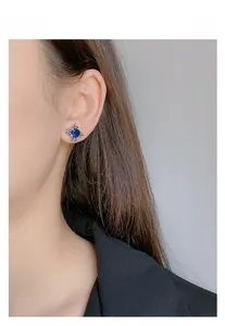 Macro shot of 925 silver retro stud earring with deep blue sapphire gemstone