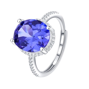 Adjustable S925 silver ring featuring a large round sapphire blue stone with halo diamonds