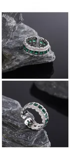 Macro detail of silver adjustable ring with square green emerald gemstones and lace edge