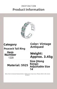 Detail of S925 sterling silver peacock feather ring with green zircon and vintage finish
