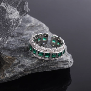 925 silver ring featuring emerald green square stones with lace-like diamond borders