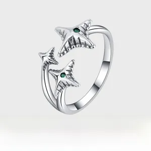 Detail of S925 silver meteor ring with vintage oxidized finish and green gemstones